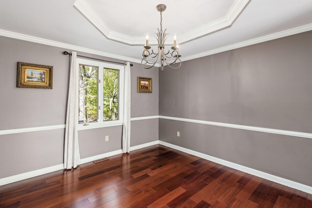 interior space featuring baseboards, visible vents, dark wood-type flooring, a raised ceiling, and a chandelier