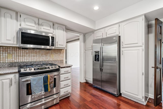 kitchen with dark wood-style floors, white cabinetry, recessed lighting, appliances with stainless steel finishes, and decorative backsplash