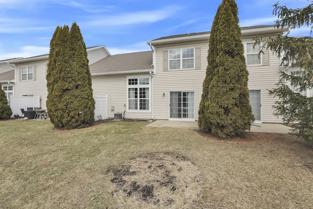 rear view of house featuring a patio area, a lawn, and central AC