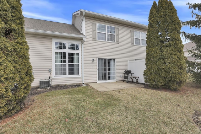 back of house featuring a yard, a patio area, cooling unit, and a shingled roof