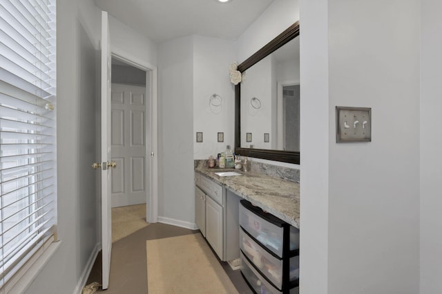 bathroom featuring vanity and baseboards