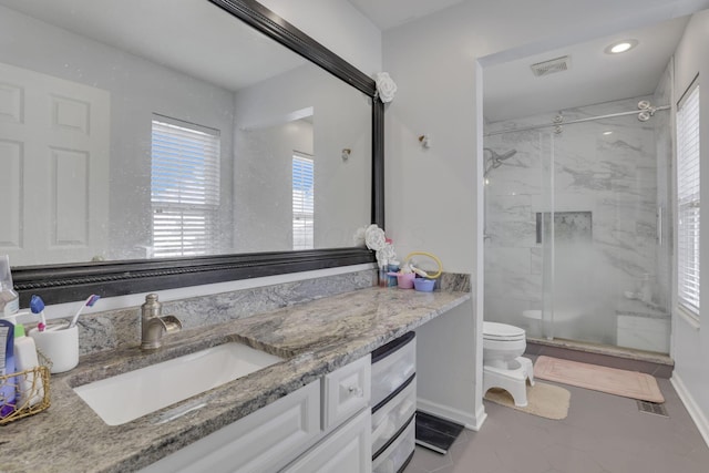 full bath with vanity, baseboards, visible vents, a marble finish shower, and toilet