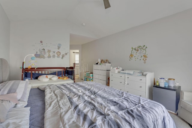 bedroom with vaulted ceiling, carpet flooring, and ceiling fan