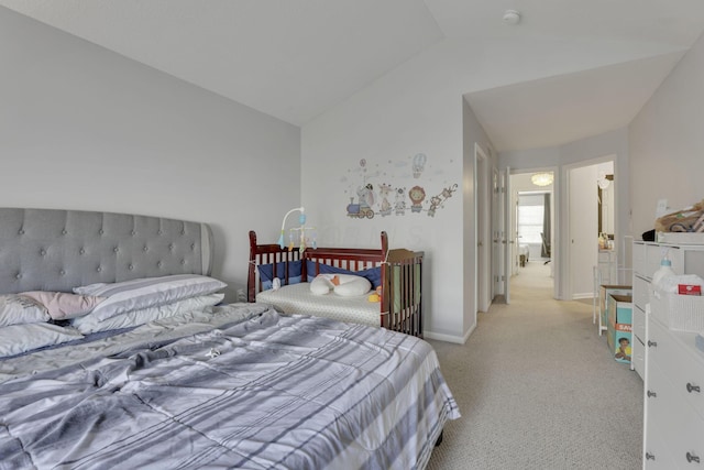 carpeted bedroom featuring vaulted ceiling and baseboards