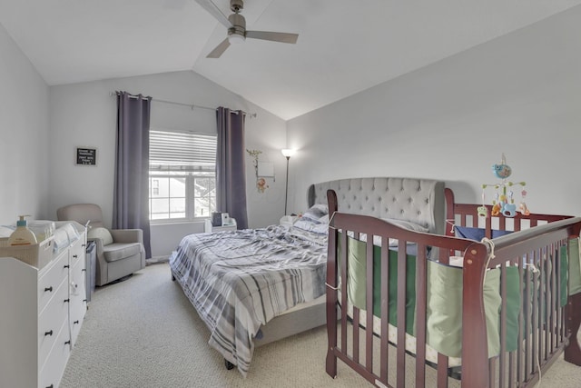 carpeted bedroom featuring lofted ceiling and ceiling fan