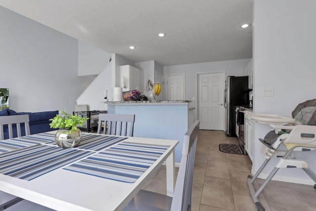 dining space with light tile patterned floors and recessed lighting