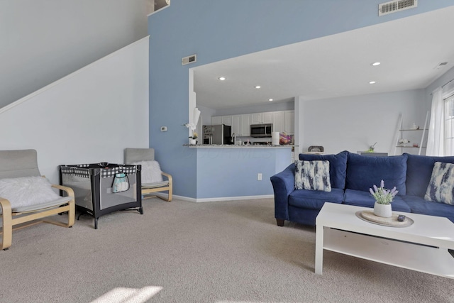 living room featuring light carpet, visible vents, recessed lighting, and baseboards