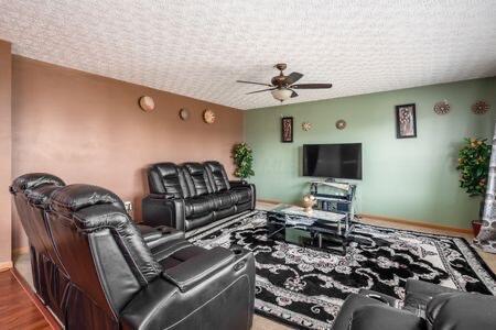 living area with a textured ceiling and ceiling fan