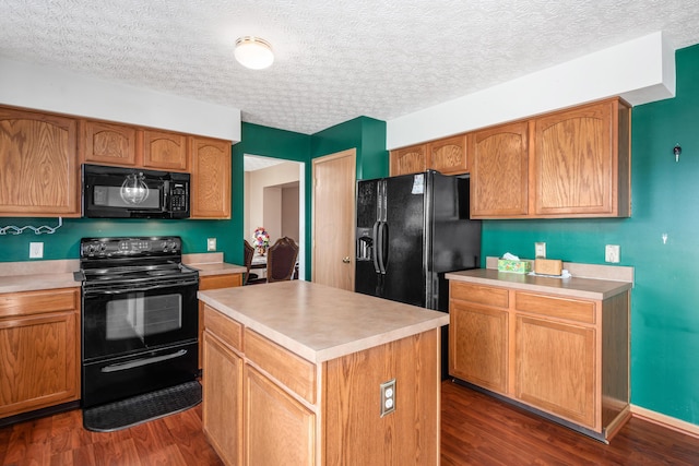 kitchen with a kitchen island, dark wood-type flooring, black appliances, and light countertops