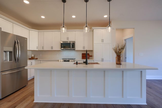 kitchen featuring a sink, stainless steel appliances, white cabinets, and light countertops