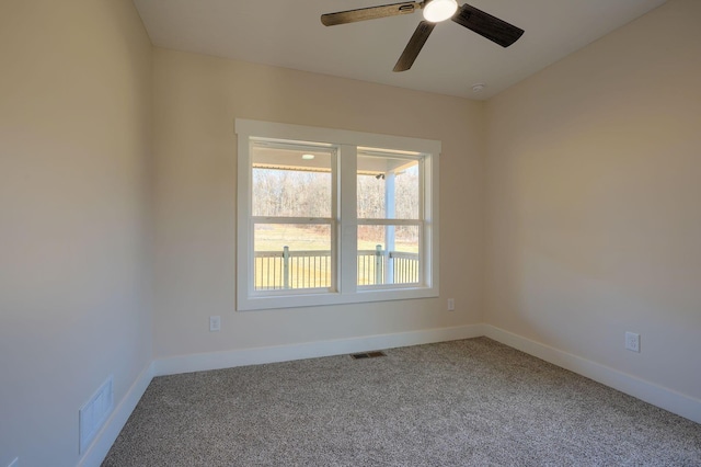 unfurnished room featuring visible vents, carpet flooring, baseboards, and ceiling fan