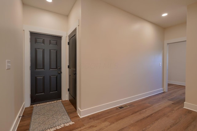 entryway featuring visible vents, recessed lighting, wood finished floors, and baseboards