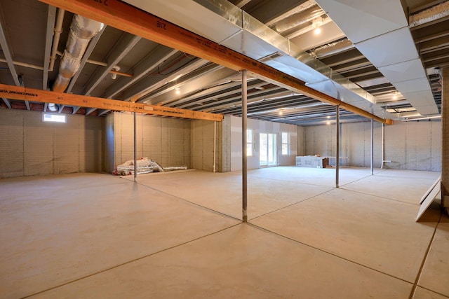 basement featuring brick wall