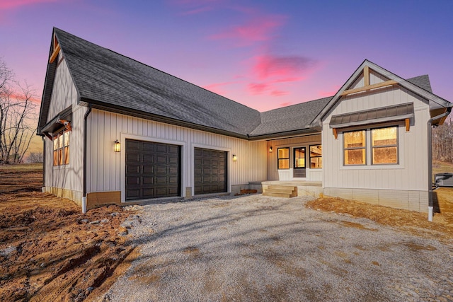 modern farmhouse style home with driveway, an attached garage, and roof with shingles