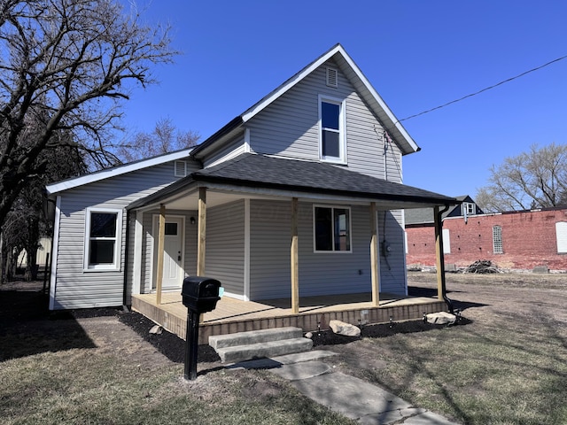 view of front of property featuring a porch and roof with shingles