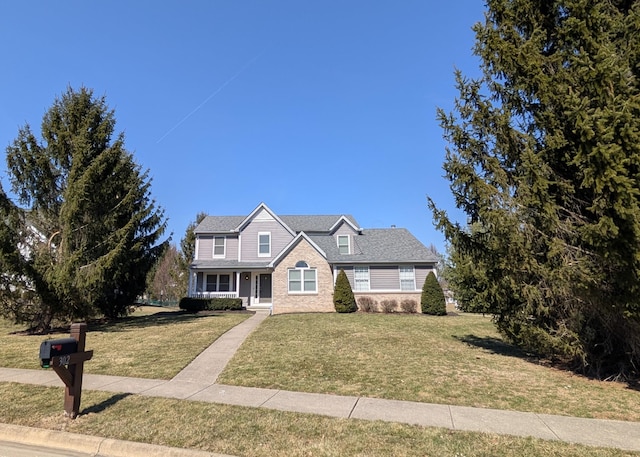 view of front of house featuring a front lawn and stone siding