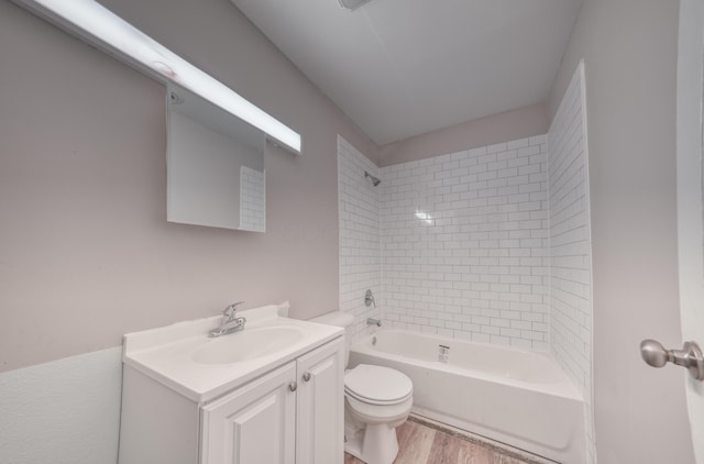 bathroom featuring vanity, shower / tub combination, toilet, and wood finished floors