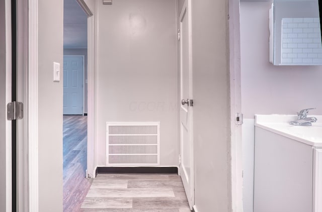 bathroom with vanity, wood finished floors, and visible vents