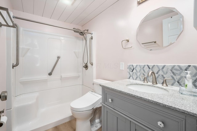 bathroom with a shower, toilet, wood ceiling, and vanity