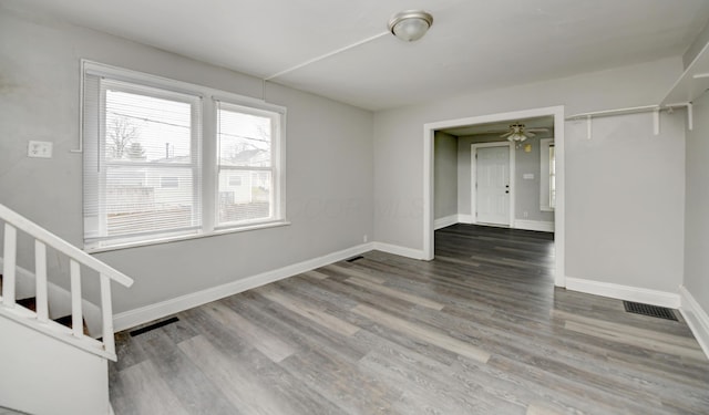 1151/1153 Heyl Ave, Columbus, OH 43206 - unfurnished room with visible vents, stairway, baseboards, and wood finished floors