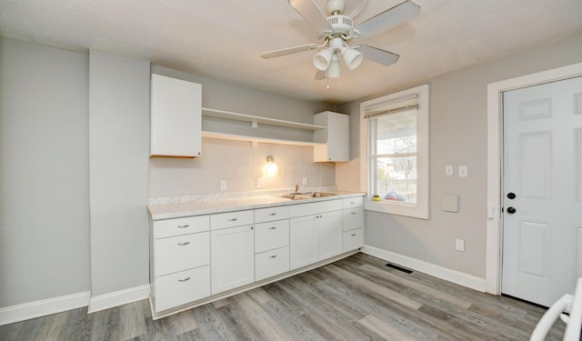 1151/1153 Heyl Ave, Columbus, OH 43206 - kitchen with open shelves, white cabinets, light countertops, and baseboards