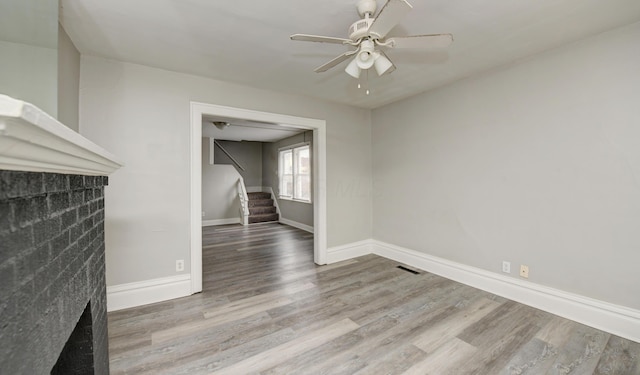1151/1153 Heyl Ave, Columbus, OH 43206 - unfurnished living room featuring wood finished floors, visible vents, baseboards, ceiling fan, and stairs
