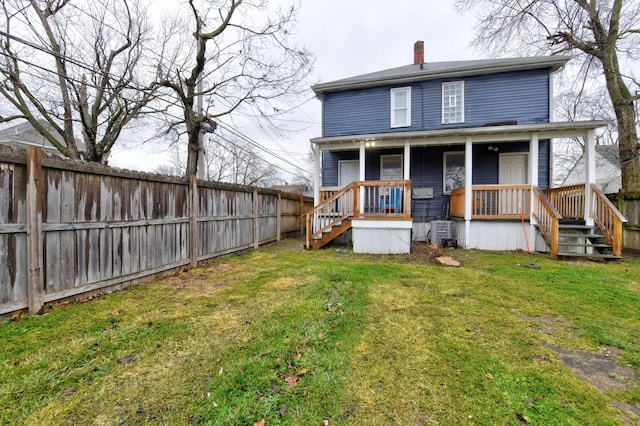1151/1153 Heyl Ave, Columbus, OH 43206 - back of property with a lawn, a porch, a chimney, and fence