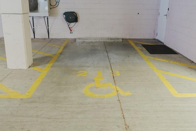 parking garage featuring concrete block wall