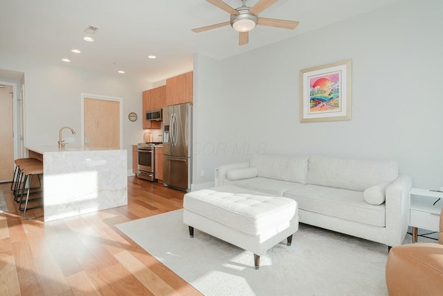 living area featuring visible vents, recessed lighting, light wood-type flooring, and ceiling fan