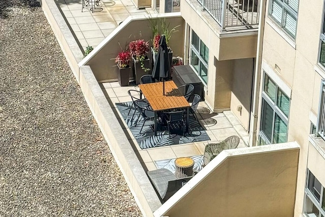 balcony featuring outdoor dining area and a patio