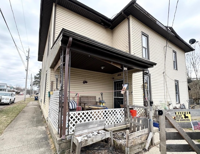 view of side of home with covered porch