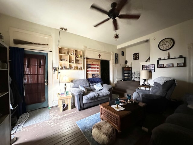 living area featuring visible vents, wood-type flooring, and ceiling fan