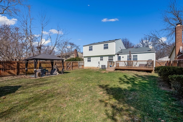 back of house featuring a wooden deck, a yard, a fenced backyard, a gazebo, and central air condition unit