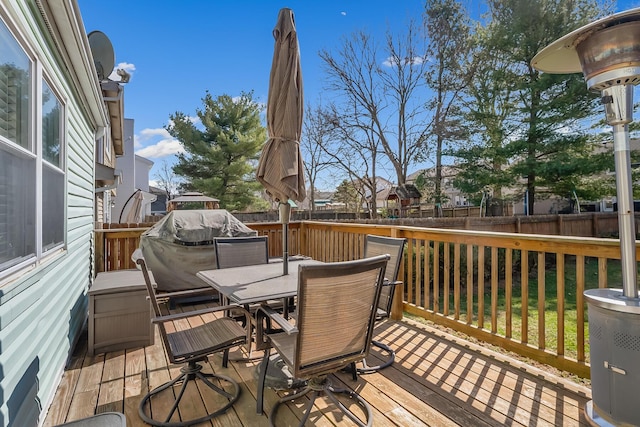 deck with a fenced backyard and outdoor dining space