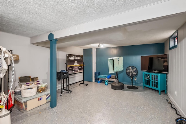 interior space featuring a textured ceiling and speckled floor