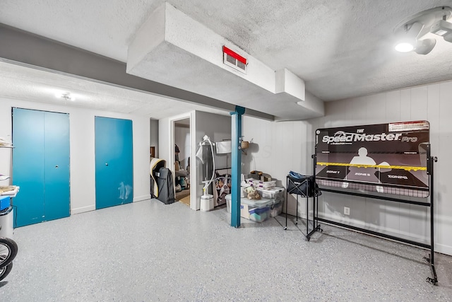 finished basement with a textured ceiling