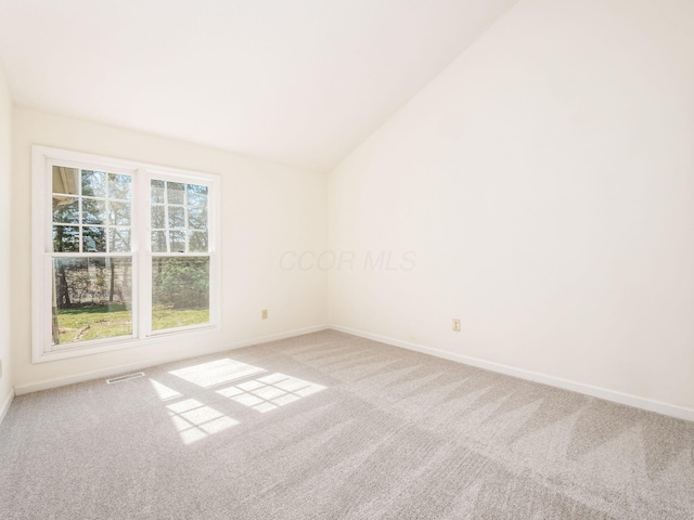 unfurnished room with lofted ceiling, baseboards, visible vents, and carpet floors