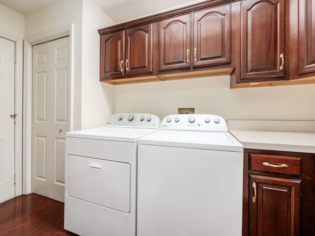 laundry room featuring dark wood finished floors, cabinet space, and separate washer and dryer