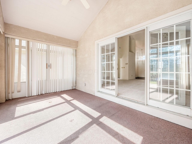 unfurnished sunroom with lofted ceiling and ceiling fan