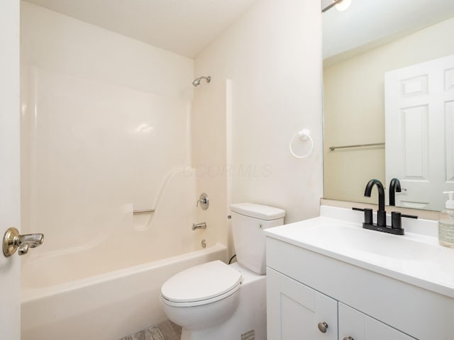 bathroom with toilet,  shower combination, and vanity