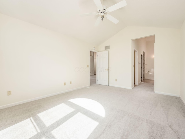 unfurnished bedroom featuring visible vents, light carpet, lofted ceiling, connected bathroom, and baseboards