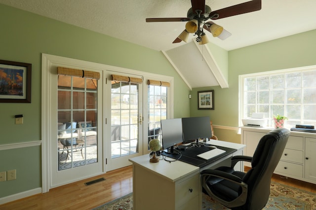 office space featuring visible vents, plenty of natural light, and light wood-style flooring