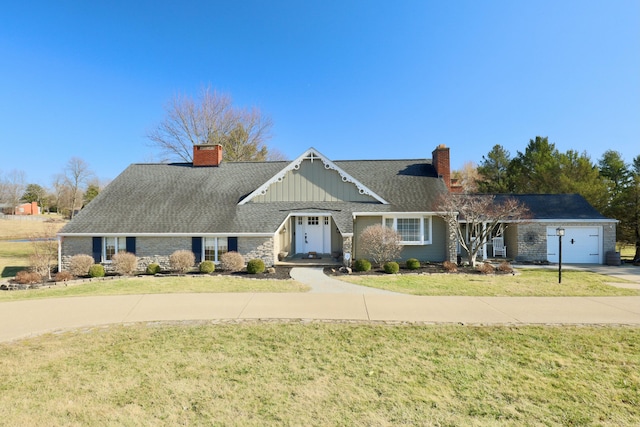 view of front of home with concrete driveway, a chimney, and a front lawn