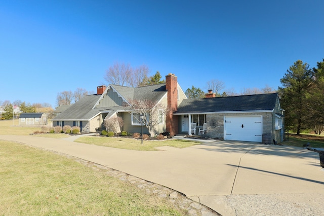 view of front of house featuring concrete driveway, a garage, a front yard, and a chimney