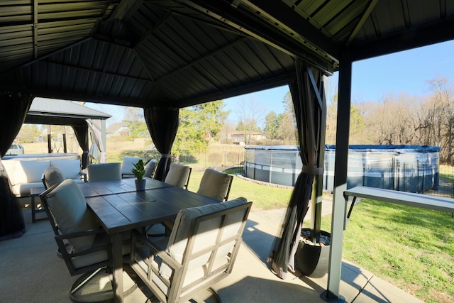 view of patio with outdoor dining space, a gazebo, and a pool