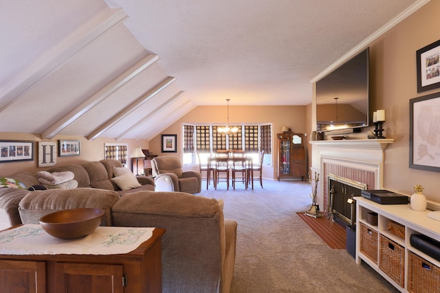 carpeted living room with vaulted ceiling, ornamental molding, a fireplace with flush hearth, and a chandelier