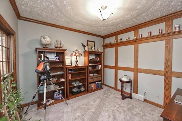 carpeted office featuring a textured ceiling, crown molding, and baseboards