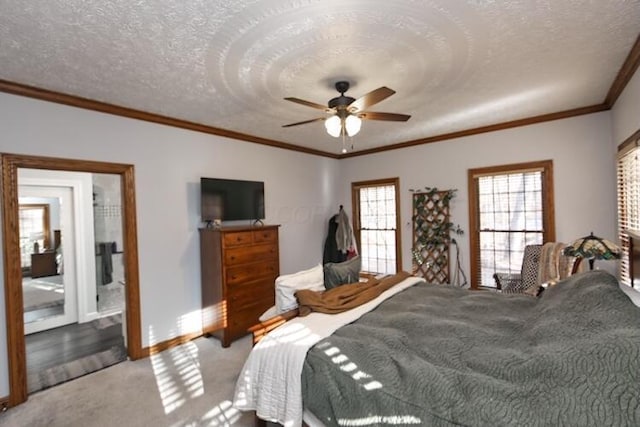 bedroom with a textured ceiling, carpet floors, crown molding, baseboards, and ceiling fan