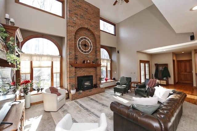 living area featuring a high ceiling and ceiling fan