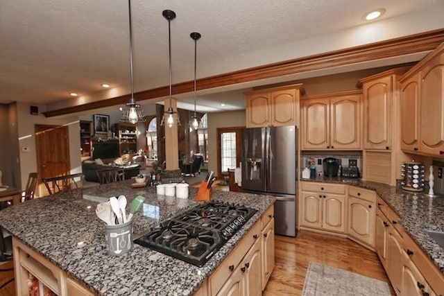 kitchen featuring a kitchen island, light brown cabinets, black gas cooktop, and stainless steel fridge with ice dispenser